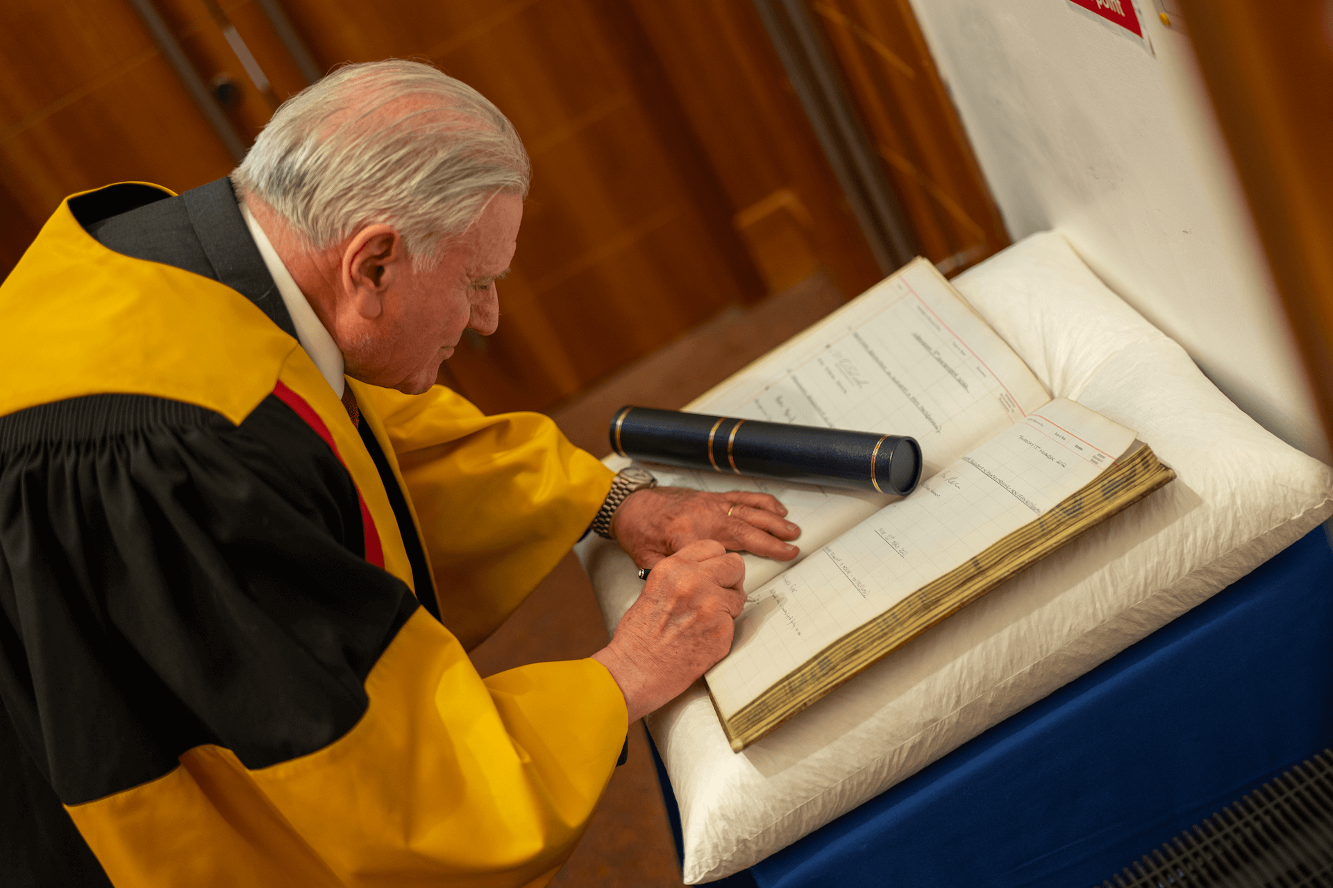 An RCPSG member signing a book