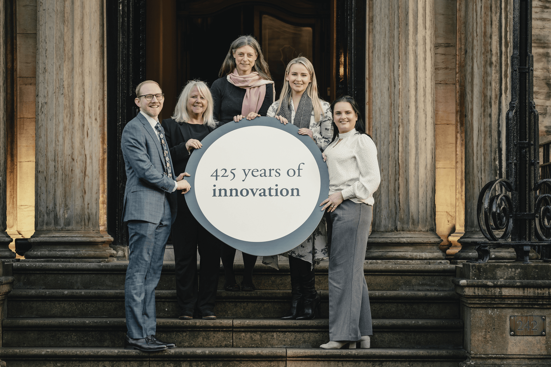 RCPSG members holding a sign that reads "425 years of innovation"