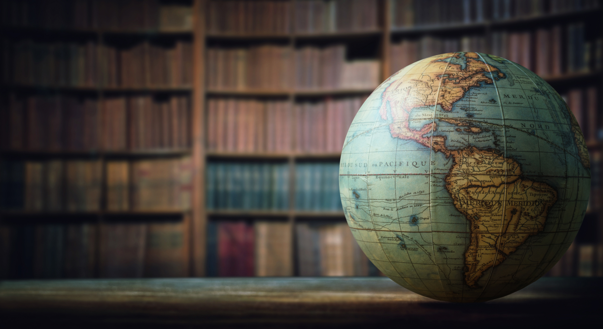 Globe in front of shelves of books 