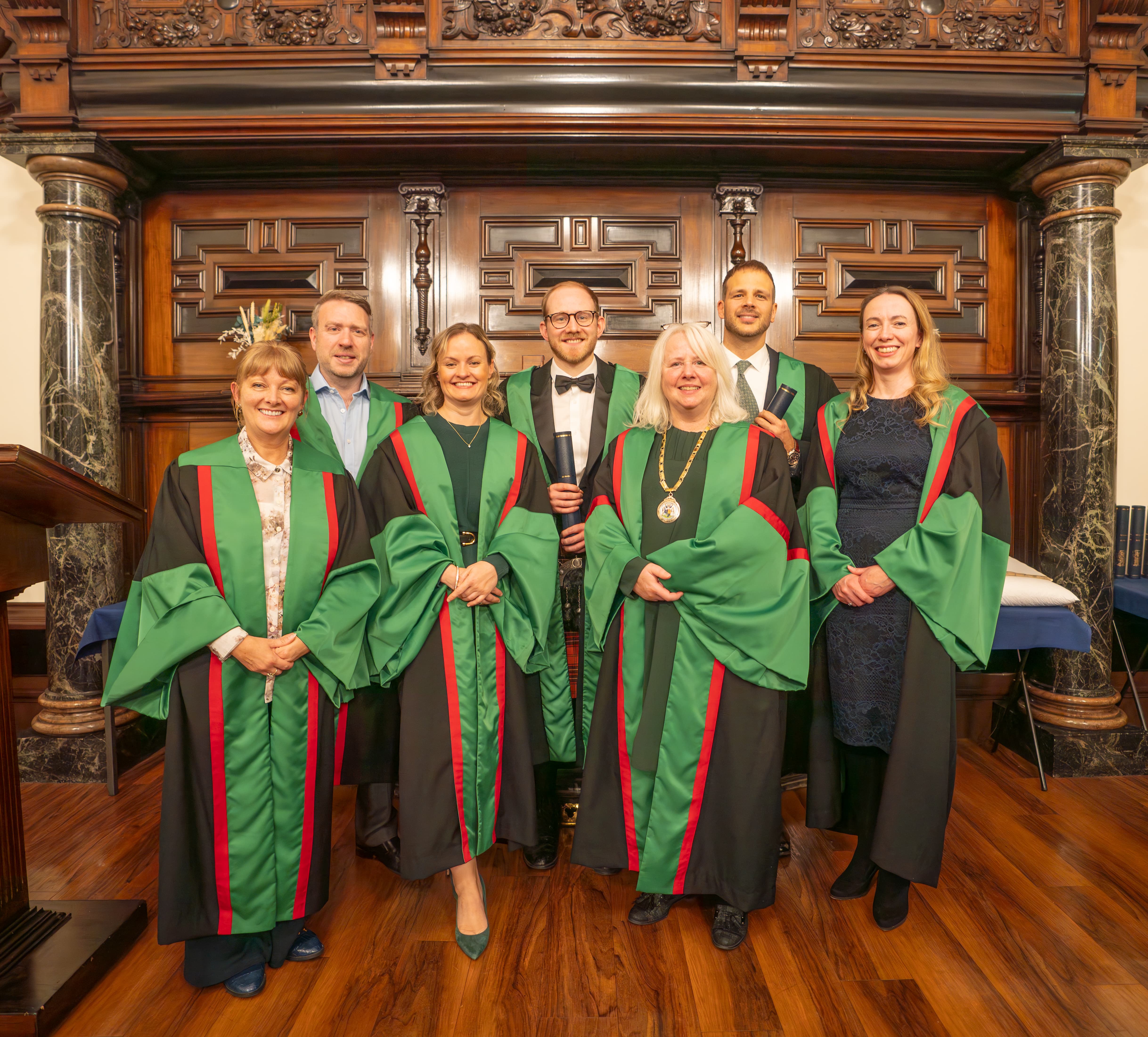 A group of dental members in ceremonial robes
