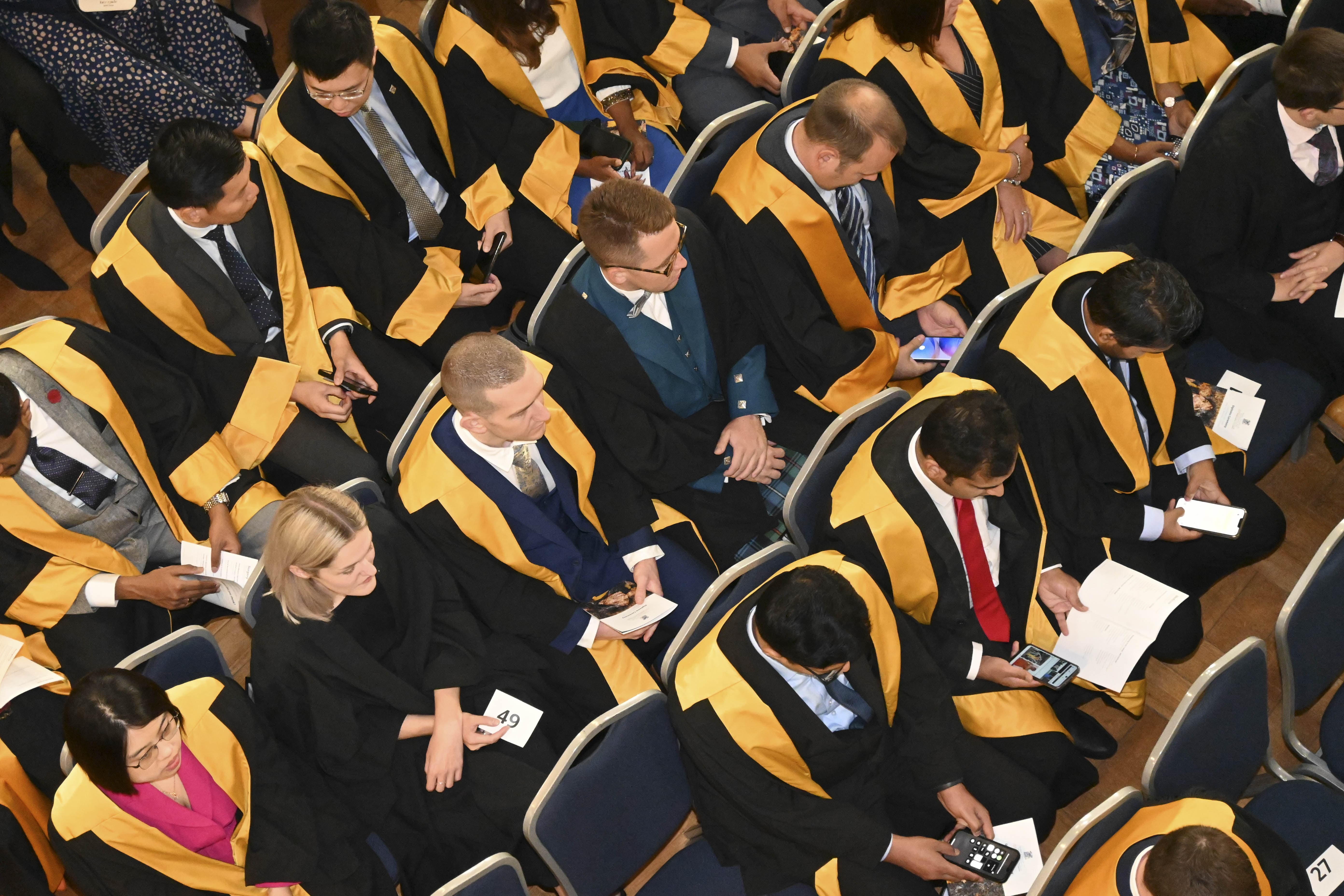a large group of graduates attending a ceremony 